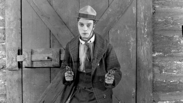 Buster Keaton Holding Pistols Black and White Desktop Wallpaper
