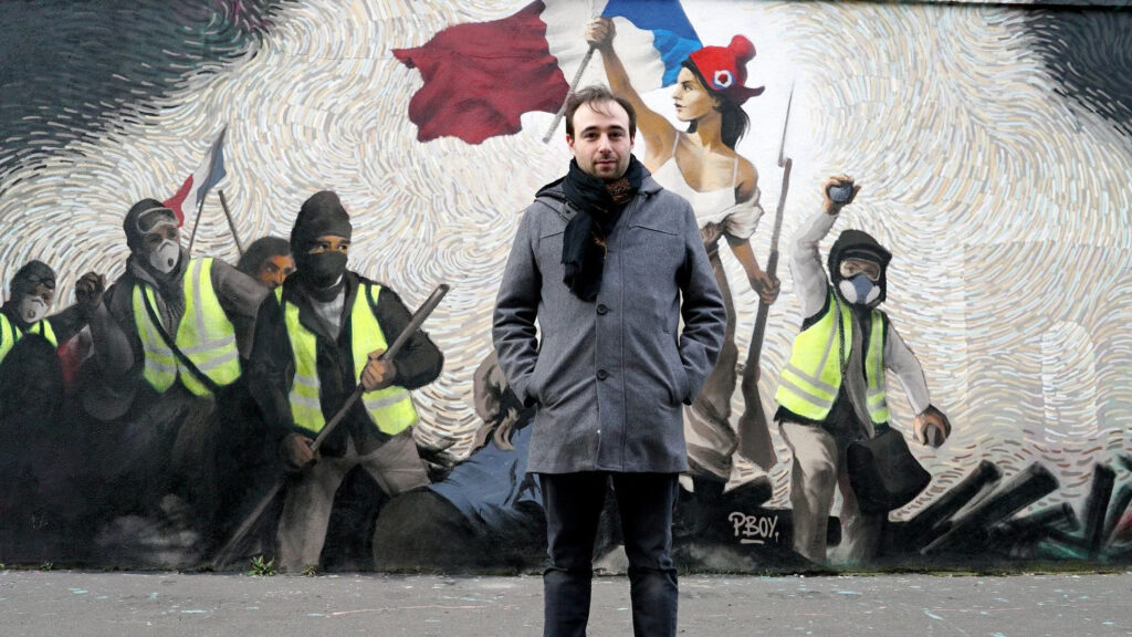 Man Standing Before Yellow Vest Protest Mural Desktop Wallpaper