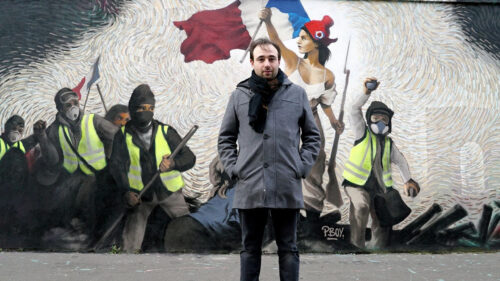 Man Standing Before Yellow Vest Protest Mural Desktop Wallpaper