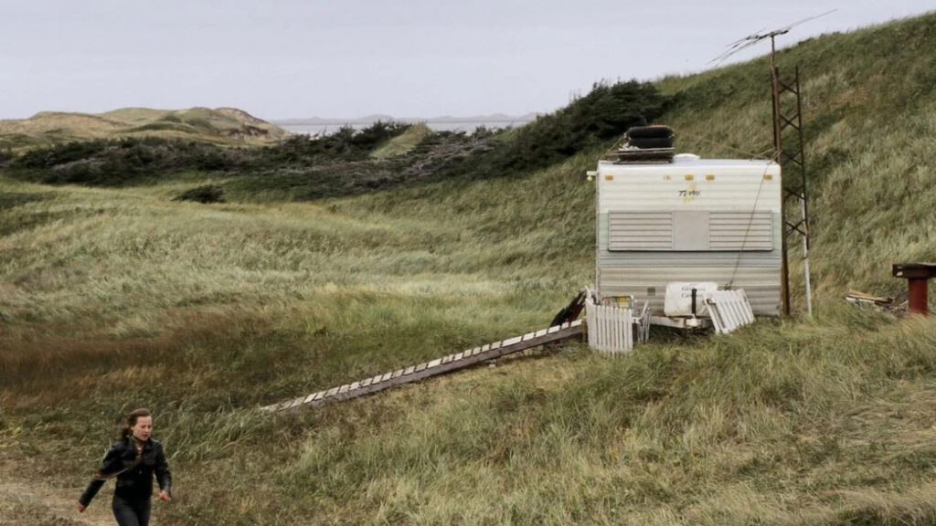 A Solitary Trailer in a Windswept Landscape Desktop Wallpaper