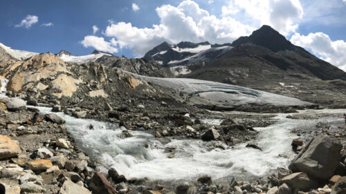 Majestic Alpine Glacier and River Flow Desktop Wallpaper
