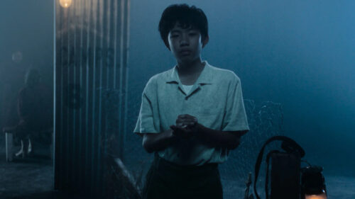 Young Boy in Moody Cinematic Night Scene Desktop Wallpaper