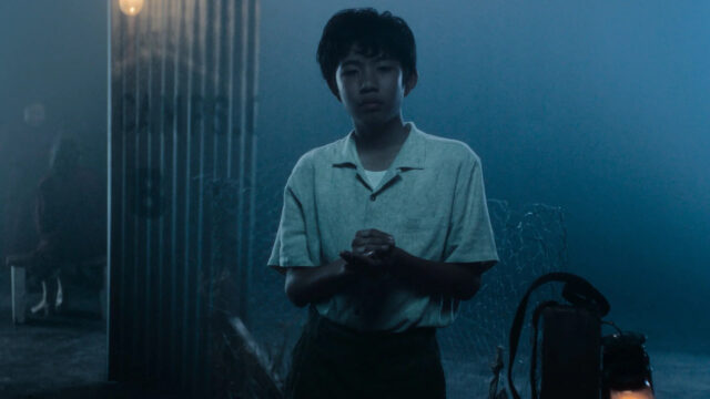 Young Boy in Moody Cinematic Night Scene Desktop Wallpaper