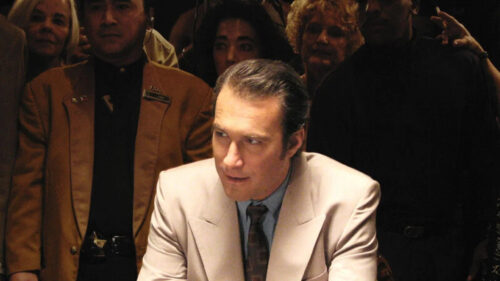 Dramatic Portrait of an Actor in a Beige Suit Desktop Wallpaper