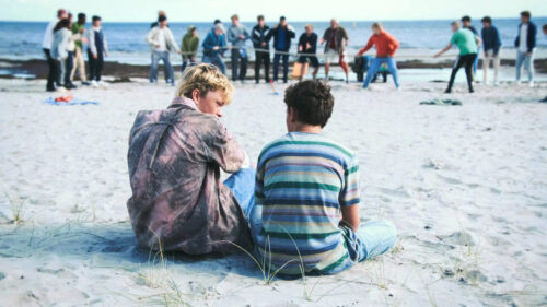 Two Friends Sitting on the Beach Desktop Wallpaper