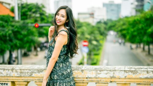 Beautiful Young Woman Posing on a Bridge in the City Desktop Wallpaper