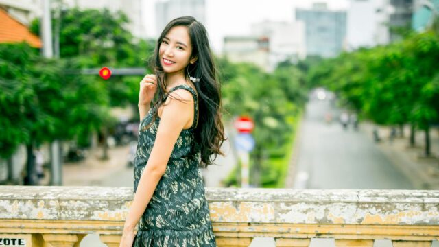 Beautiful Young Woman Posing on a Bridge in the City Desktop Wallpaper