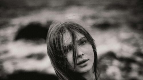 Moody Portrait of a Young Woman with Flowing Hair 4K Desktop Wallpaper