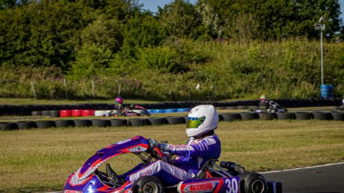 Professional Kart Racing Driver on Track 4K Wallpaper