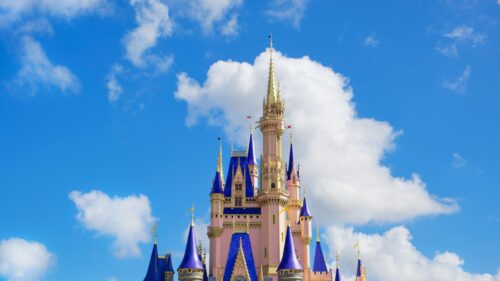 Magical Pink Disney Castle Under Bright Blue Sky 4K Wallpaper