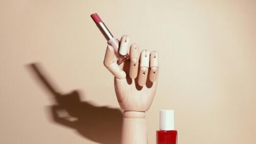 Minimalist Makeup Aesthetic with Lipstick and Wooden Hand 4K Wallpaper