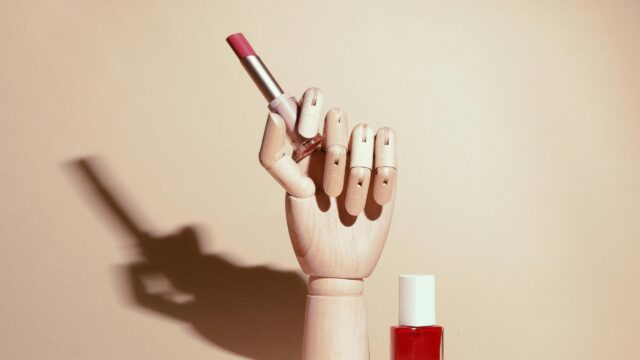 Minimalist Makeup Aesthetic with Lipstick and Wooden Hand 4K Wallpaper
