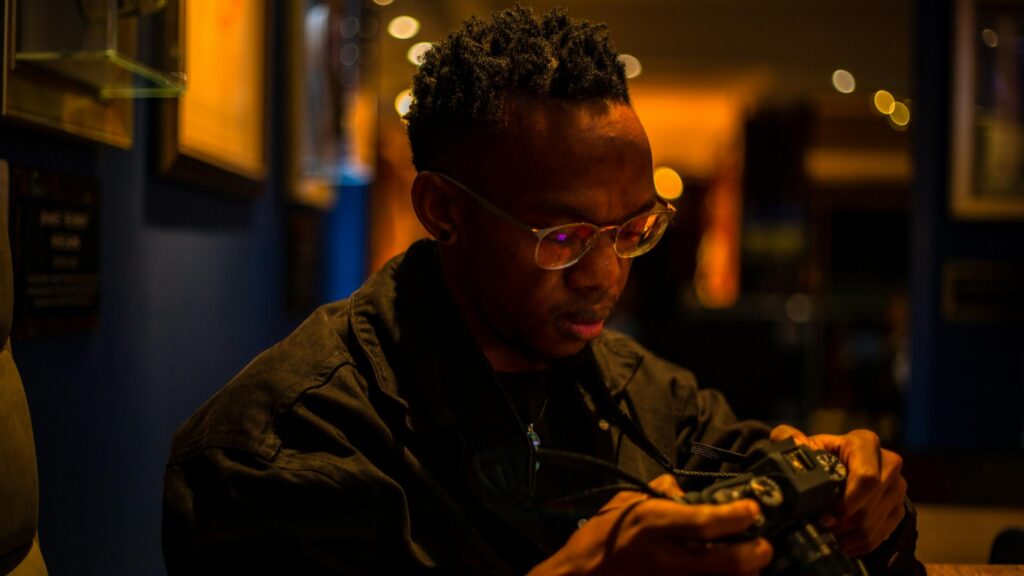 Focused Photographer Adjusting Camera Settings 4K Desktop Wallpaper