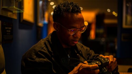 Focused Photographer Adjusting Camera Settings 4K Desktop Wallpaper