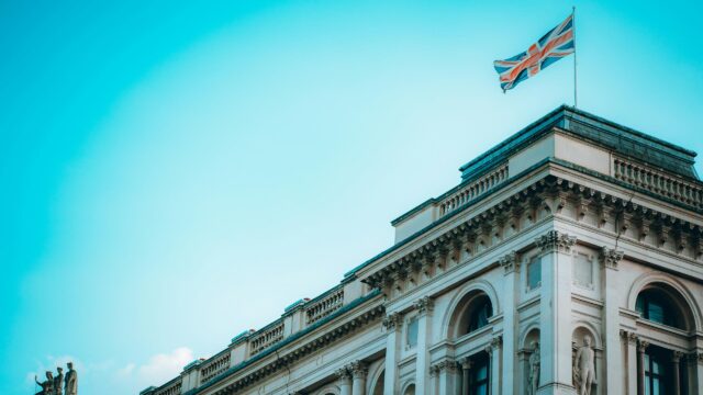 British Union Jack Flag Flying Over Neoclassical Architecture 4K Wallpaper