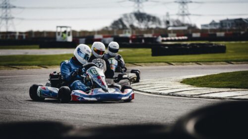 Professional Go-Kart Racing Trio on Track Desktop Wallpaper