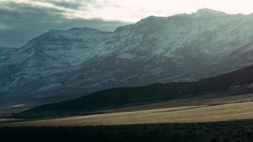 Majestic Snow Capped Mountain Range at Golden Hour 4K Wallpaper