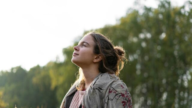 Dreamy Young Woman Looking Up at Nature 4K Desktop Wallpaper