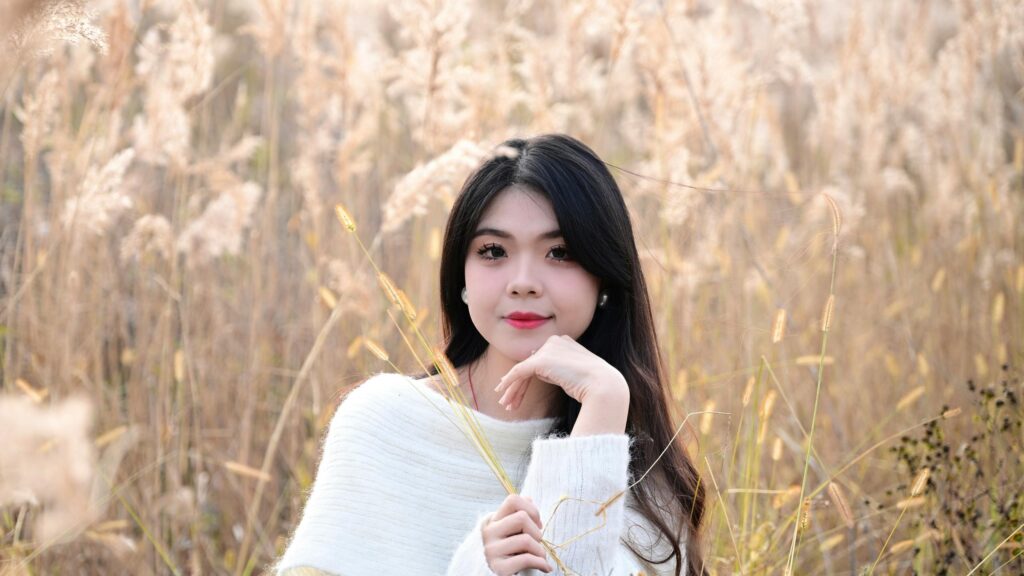 Beautiful Asian Girl in Golden Tall Grass Field 4K Wallpaper