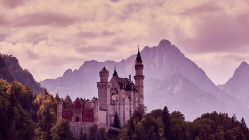 Neuschwanstein Castle in Bavarian Alps at Sunset Desktop Wallpaper