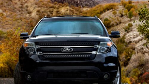 Black Ford Explorer SUV Front View on Mountain Road Desktop Wallpaper