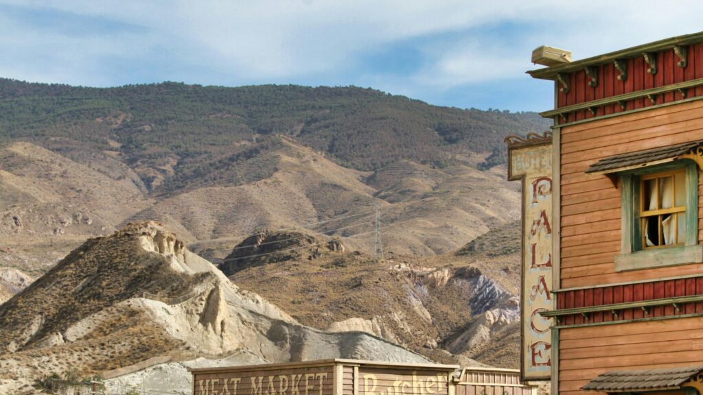 Wild West Palace Hotel Sign and Desert Mountains Desktop Wallpaper