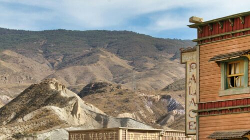 Wild West Palace Hotel Sign and Desert Mountains Desktop Wallpaper