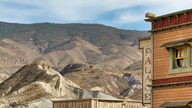 Wild West Palace Hotel Sign and Desert Mountains Desktop Wallpaper