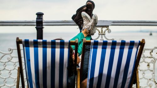 Relaxing Seaside Deck Chair Couple View 4K Desktop Wallpaper