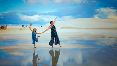 Mother and Daughter Joyful Dancing at White Sands 4K Desktop Wallpaper