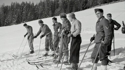Vintage Soldiers Training on Skis in Snowy Mountains Desktop Wallpaper