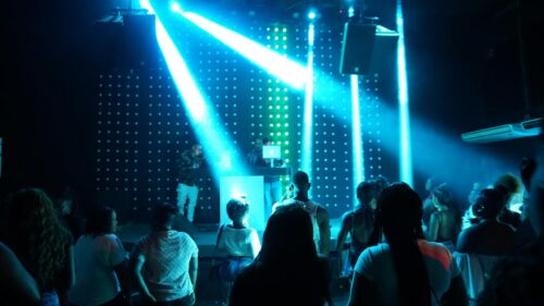 Nightclub Party Crowd with Blue Stage Lights 4K Wallpaper