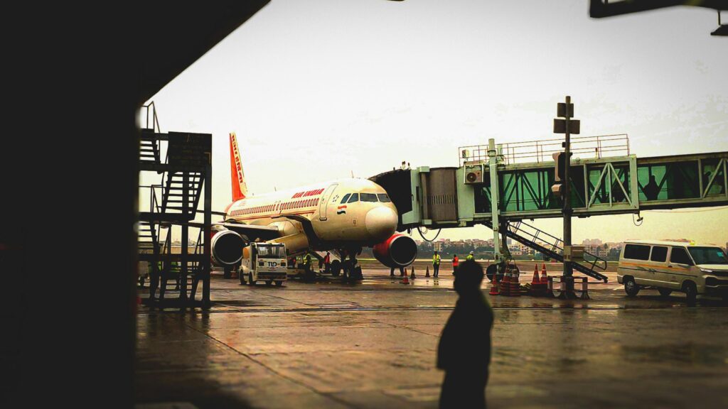 Air India Plane at Airport Gate Rainy Day 4K Wallpaper