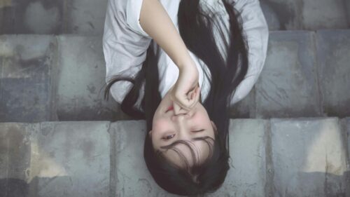 Beautiful Young Asian Woman With Long Dark Hair Winking Desktop Wallpaper