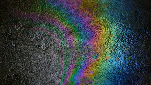 Mesmerizing Rainbow Oil Slick on Asphalt 4K Wallpaper