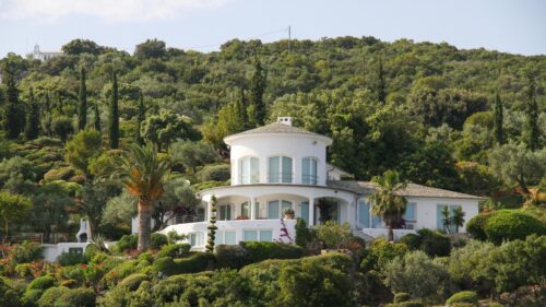 Mediterranean White Villa Nestled in Lush Hillside Forest 4K Wallpaper
