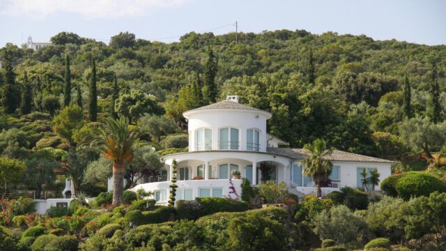 Mediterranean White Villa Nestled in Lush Hillside Forest 4K Wallpaper