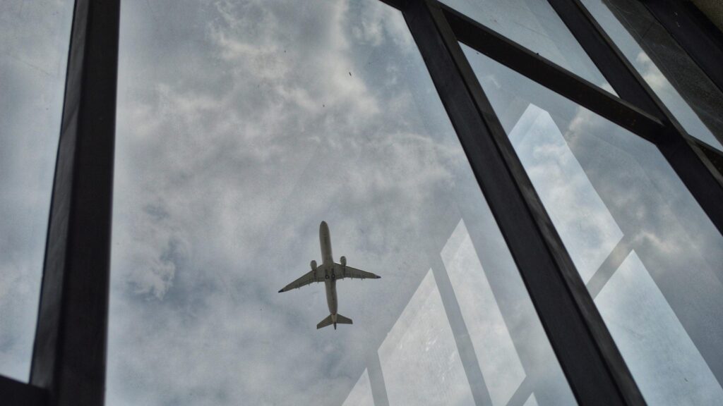 Airplane Soaring Through Cloudy Sky View From Window 4K Wallpaper