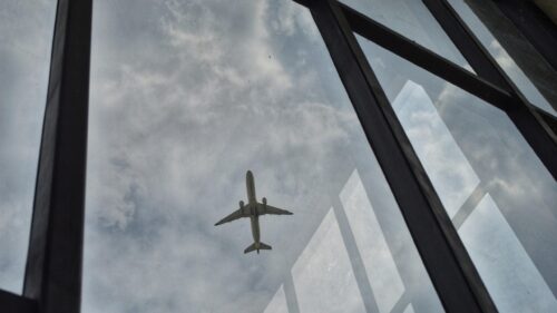 Airplane Soaring Through Cloudy Sky View From Window 4K Wallpaper