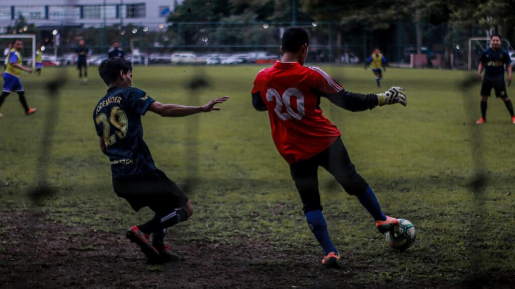 Intense Goalkeeper Save in Soccer Match Desktop Wallpaper