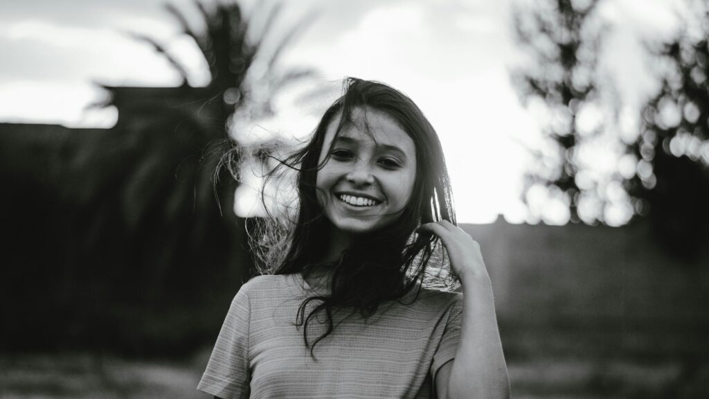 Smiling Girl with Flowing Hair Black and White Desktop Wallpaper