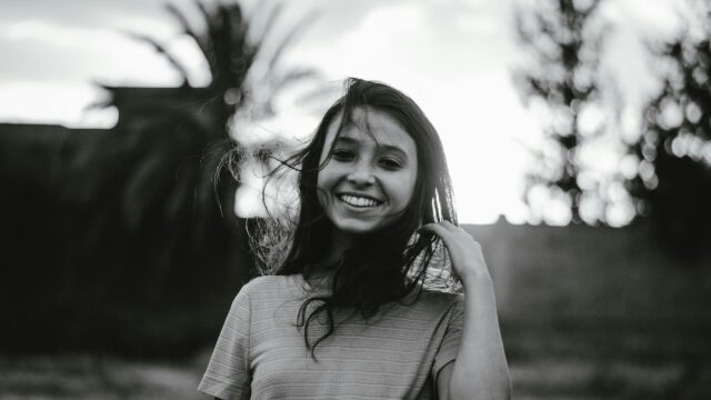 Smiling Girl with Flowing Hair Black and White Desktop Wallpaper