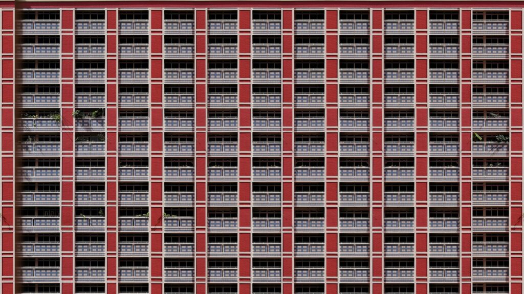 Symmetrical Red Apartment Building Architecture 4K Wallpaper