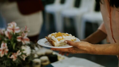 Close-up of Woman Holding Plate with Creamy Peach Dessert PC Wallpaper