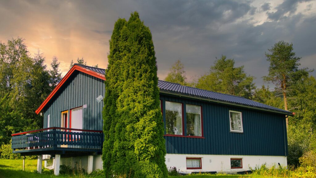 Dark Blue Cottage Under Stormy Sunset Sky Desktop Wallpaper