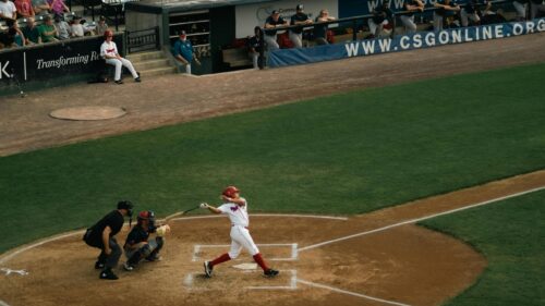 Batter Mid-Swing at a Baseball Game Desktop Wallpaper