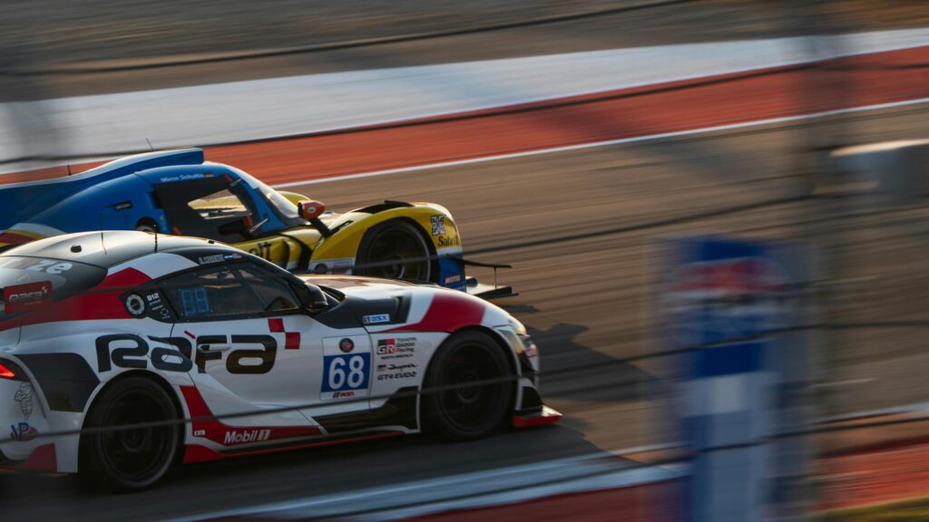Toyota GR Supra and Race Car Duel on Track Desktop Wallpaper