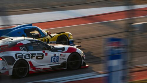 Toyota GR Supra and Race Car Duel on Track Desktop Wallpaper