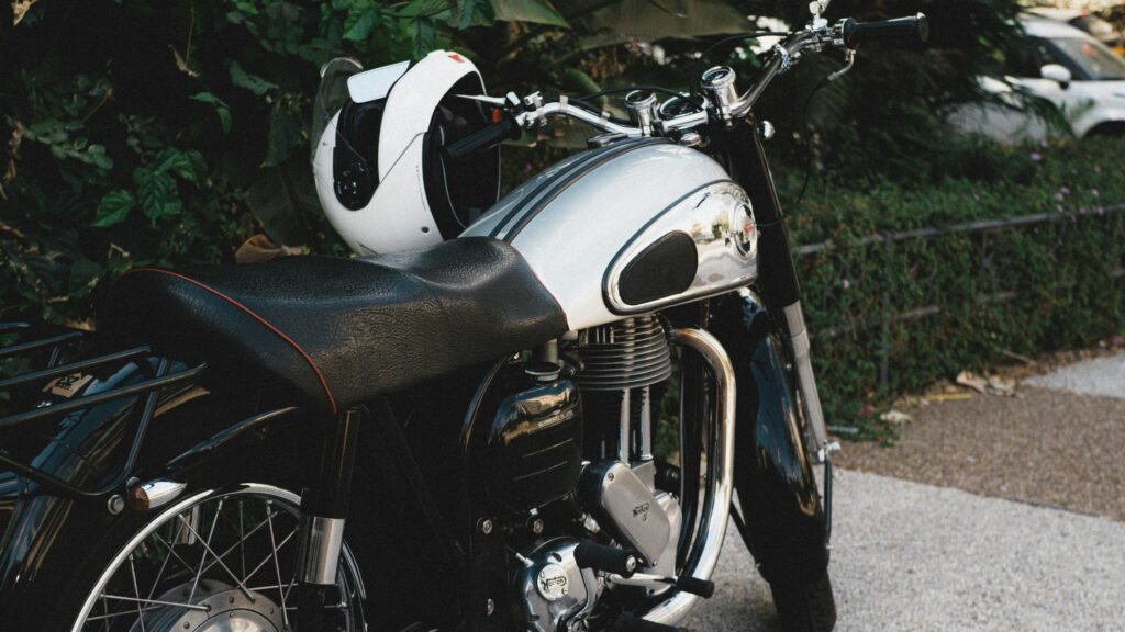 Classic Norton Motorcycle with White Helmet Desktop Wallpaper