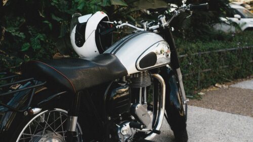 Classic Norton Motorcycle with White Helmet Desktop Wallpaper